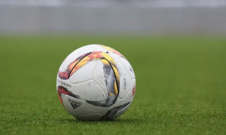 A Football Ball on a Stadium Grass Field