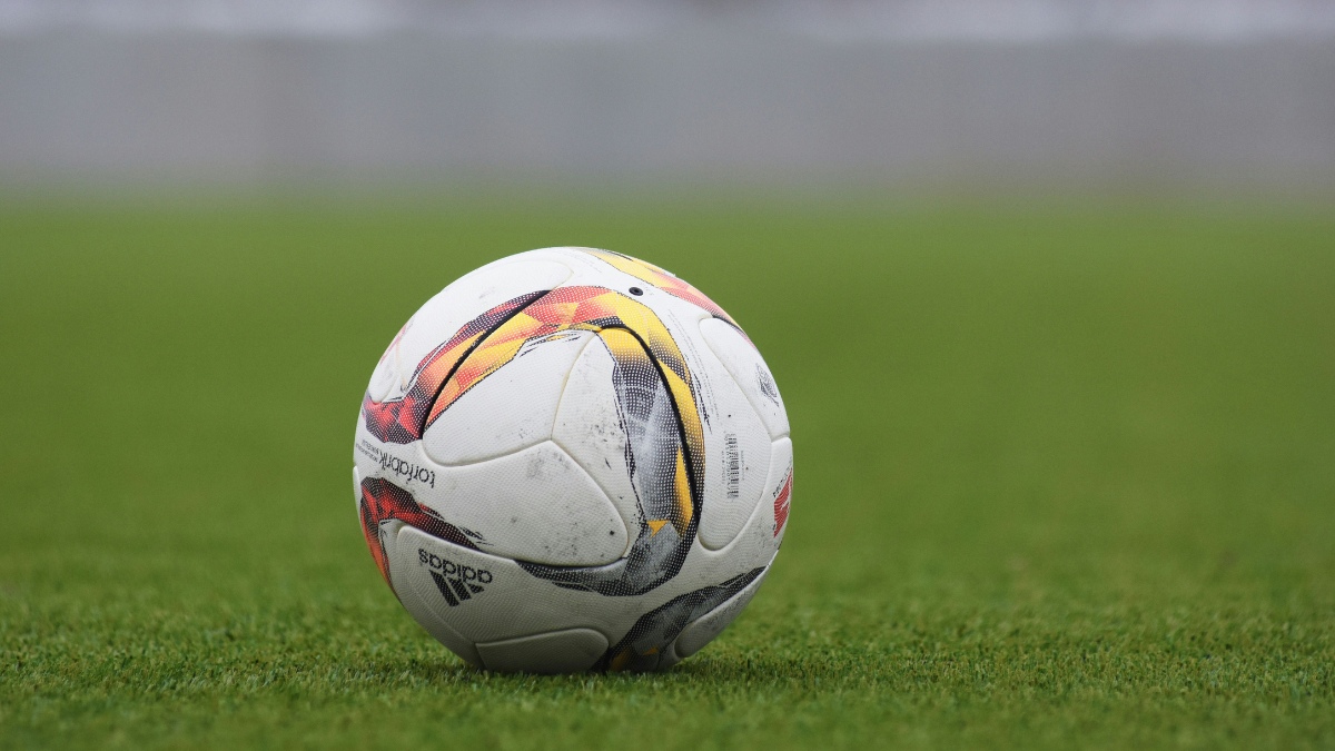 A Football Ball on a Stadium Grass Field